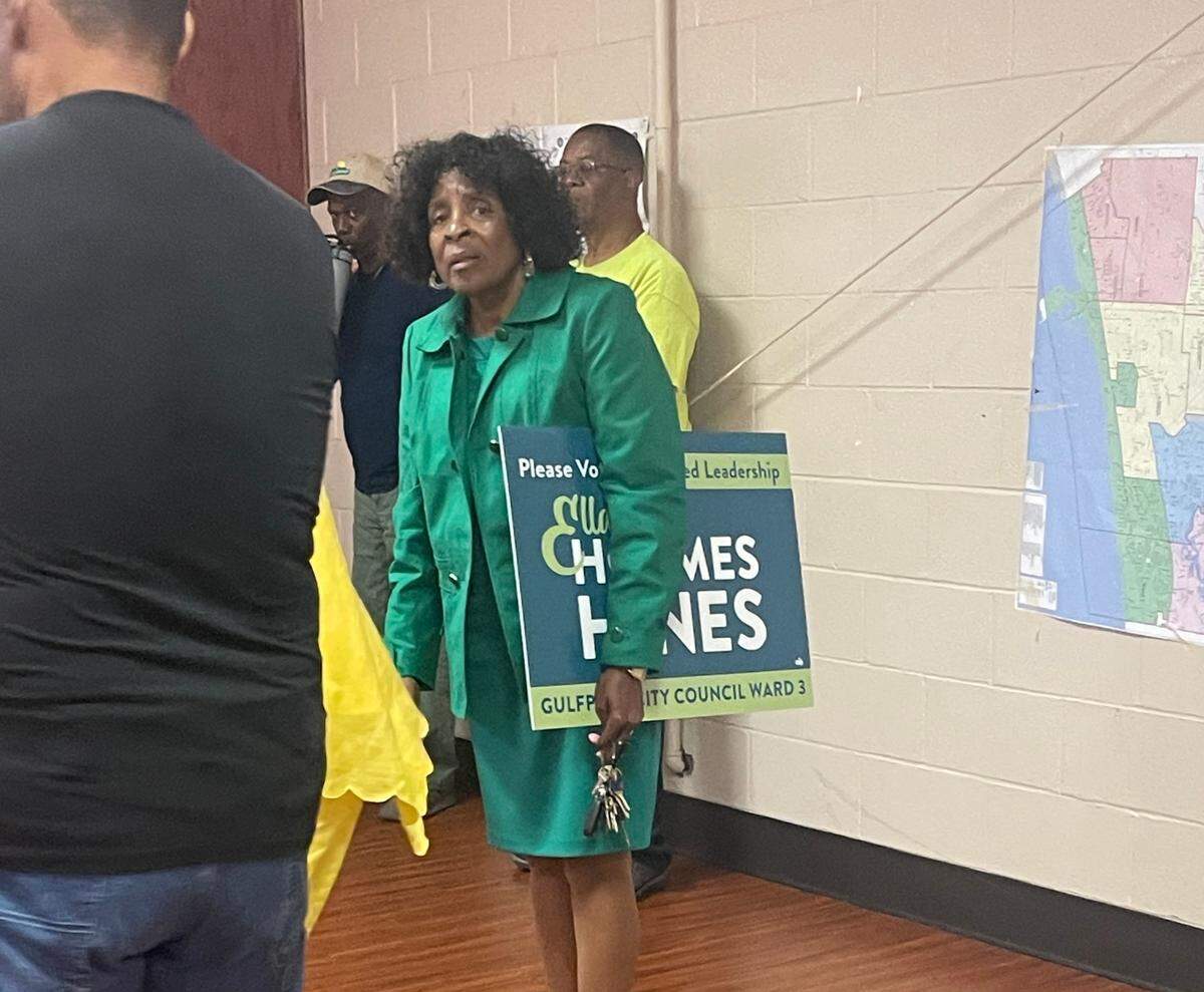 Gulfport Ward 3 City Councilwoman Ella Holmes-Hines holds one of her campaign signs under her arm while standing in a voting precinct during the April 1 primary election. While its forbidden to have campaign signs in a voting precinct during an election, Holmes-Hines said someone called for help and she had forgotten about the sign when she went inside.