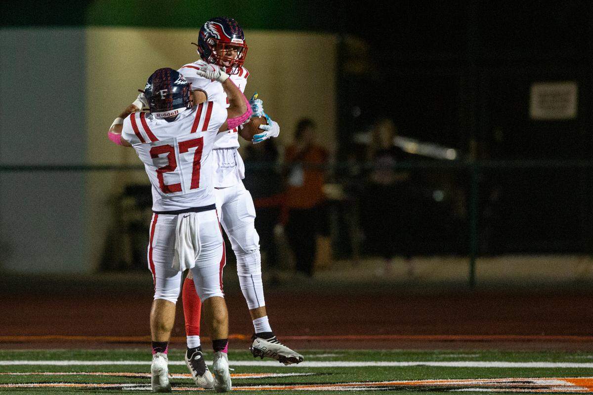 Hancock’s Neil Acker and Jeffery Hopgood celebrate after a touchdown during a game at West Harrison High School in Harrison County on Friday, Oct. 6, 2023.