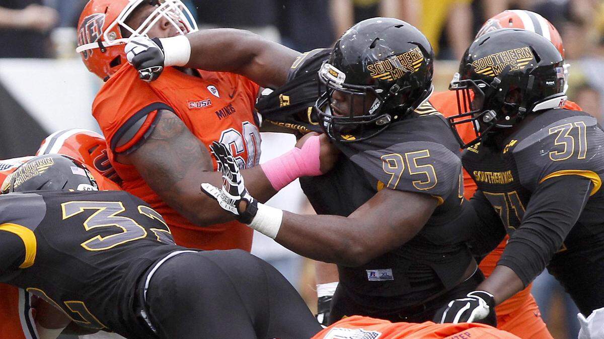 TIM ISBELL/SUN HERALD 
 Southern Miss defensive lineman Andrew Bolton mixes it up with UTEP's Eric Lee on Oct. 31 in Hattiesburg.