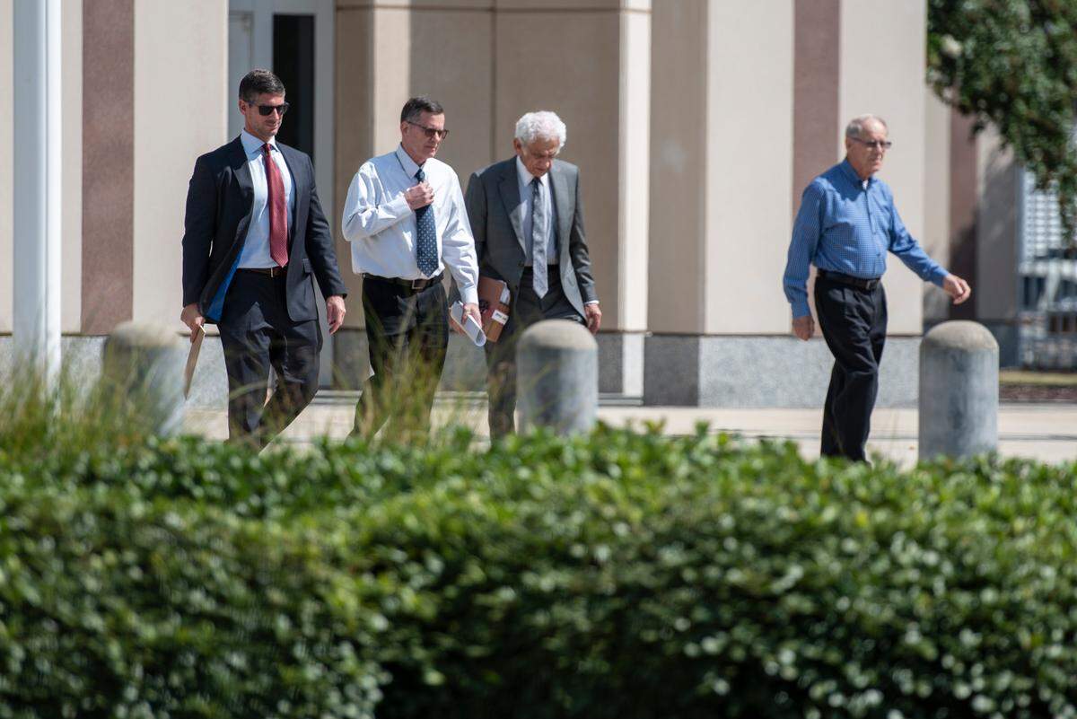 James “Jim” Gunkel, center left, walks out of Dan M. Russell Jr. Courthouse in Gulfport on Tuesday, Aug. 27, 2024, after pleading guilty to a misdemeanor charge of mislabeling seafood.