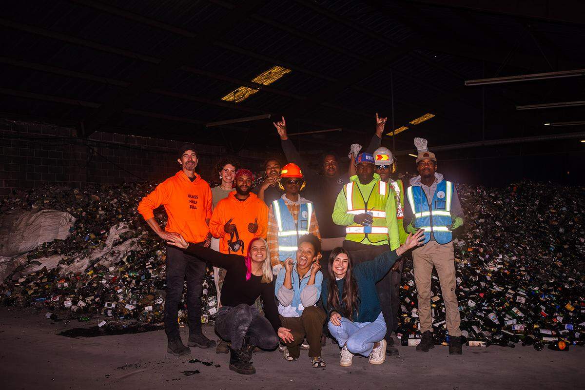 Glass Half Full staff members pose for a photo in their New Orleans recycling warehouse.