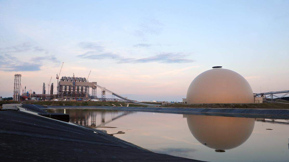 At the Kemper Counry energy facility, the lignite dome at right, can hold up to 100,000 tons of fuel for the gasifier shown at left. Under a proposed agreement between Mississippi Power and the Public Service commission, residential customers would get a one-time credit of approximately $22 on their bills, which is the difference between an emergency rate increase collected since August and the rates in the agreement, which would be reduced for residential customers by approximately $4.70 for customers using 1,000 kilowatt hours a month.