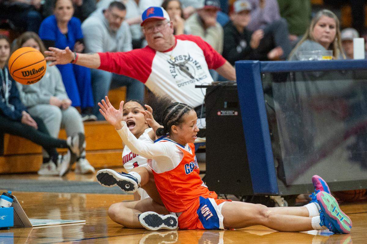 The game announcer reaches for the ball as Hancock’s Talana Bond and Gulfport’s Madison O’Dell slide out of bounds going for the ball during a game against Gulfport at Hancock High School in Kiln on Tuesday, Jan. 10, 2023.