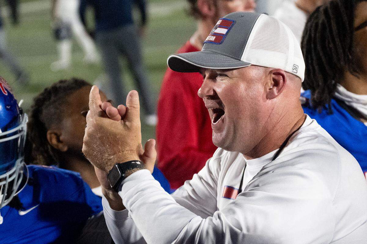 Pass Christian head coach Jeff Stockstill celebrates Friday after the Pirates region-clinching win over Moss Point.