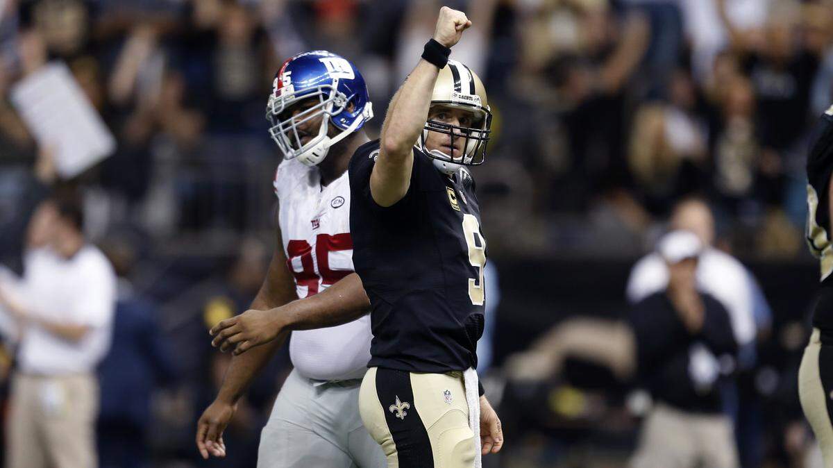 New Orleans Saints quarterback Drew Brees (9) reacts after throwing a touchdown pass to running back C.J. Spiller in the second half of an NFL football game in New Orleans, Sunday, Nov. 1, 2015. The pass tied the NFL record for the most touchdown passes thrown in a single game. The Saints won 52-49. (AP Photo/Butch Dill)