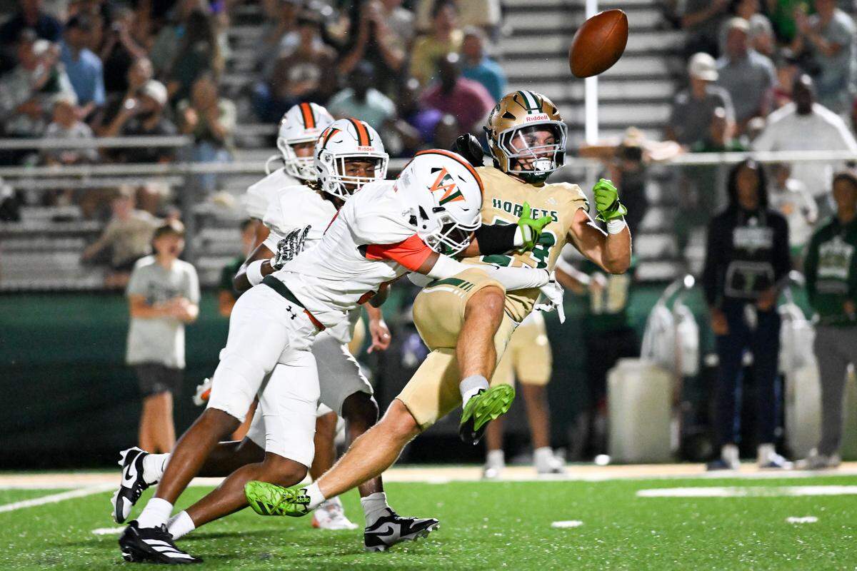 Poplarville’s Remy Naquin (23) fumbles after being tackled by West Harrison’s Dean Hunter (9).