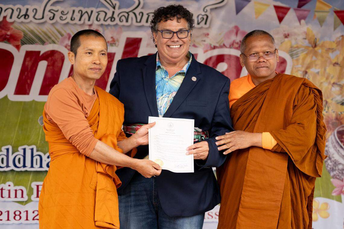 Gautier Mayor Casey Vaughn, middle, and Pisit Opnititanit, left, during Songkran at the Wat Buddhametta Mahabaramee in Gautier on Sunday, April 19, 2026.