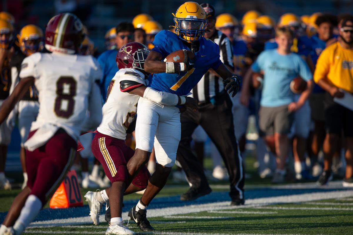 St. Martin’s Monclair Brave (#7) gets tackled as he runs the ball during a Jamboree game against George County at St. Martin High School in Ocean Springs on Friday, Aug. 23, 2024.