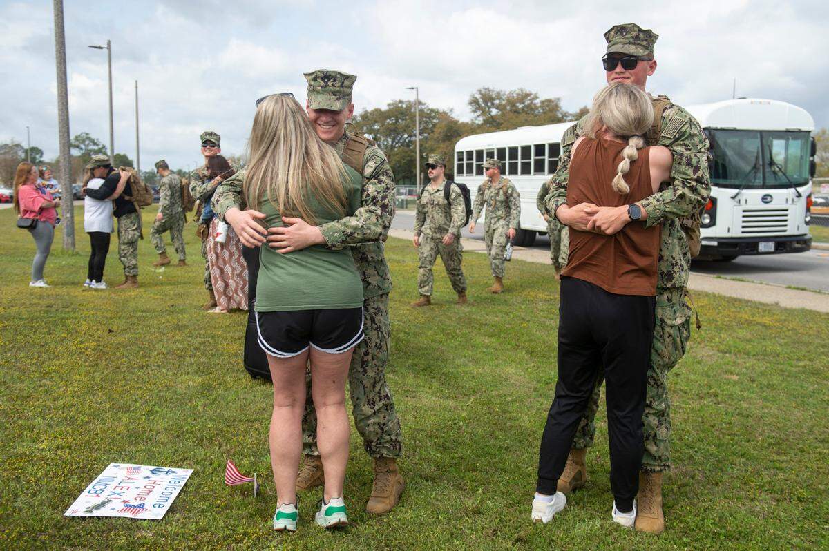 Stephanie West and her son Alex West, left, embrace as members of Naval Mobile Construction Battalion 1 return home from deployment to their families on Thursday, March 13, 2025, to Naval Construction Battalion Center Gulfport.