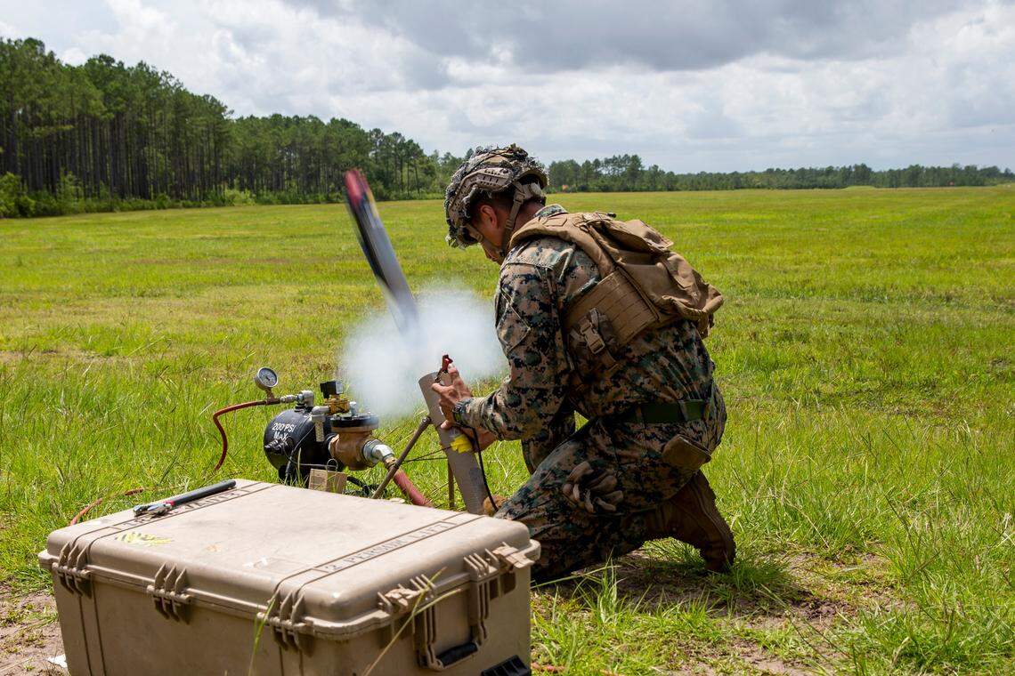 U.S. Marine Corps Lance Cpl. Isiah Enriquez, a native of Lubbock, Texas, and a rifleman with 1st Battalion, 2d Marine Regiment (1/2), 2d Marine Division (2d MARDIV), launches a Switchblade Drone during a training exercise at Camp Lejeune, N.C., July 7, 2021. 1/2 is tasked as 2d MARDIV’s experimental infantry battalion to test new gear, operating concepts and force structures. The unit’s findings will help refine infantry battalions across the Marine Corps in accordance with Force Design 2030. (U.S. Marine Corps photo by Pfc. Sarah Pysher)