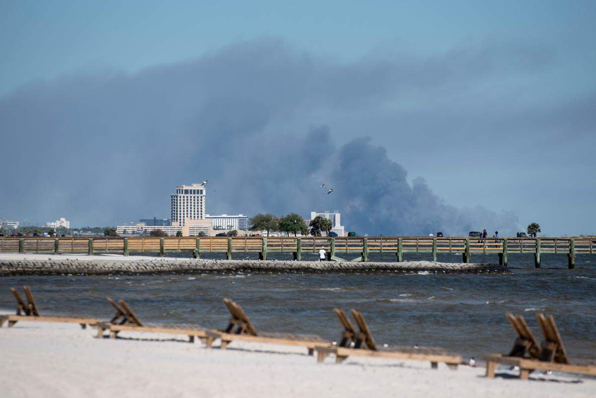 Smoke from a forest fire burning near Gulf Park Estates is visible from Biloxi Beach on Saturday, April 9, 2022.