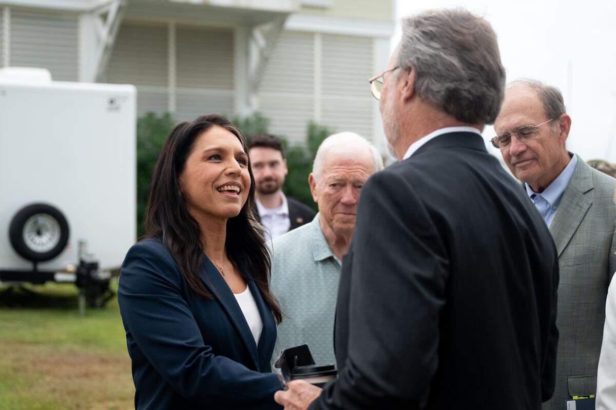 Director of National Intelligence Tulsi Gabbard shakes hands with Mayor of Gulfport Hugh Keating during a 20th anniversary commemoration of Hurricane Katrina at the Barksdale Pavilion in Gulfport on Friday, August. 29, 2025.