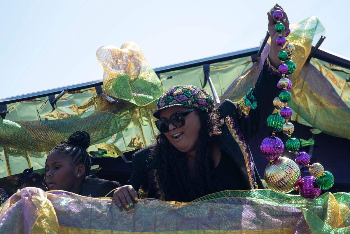 Krewes toss beads and other throws during the Jackson County Carnival Association Mardi Gras parade in Pascagoula on Saturday, March 1, 2025.