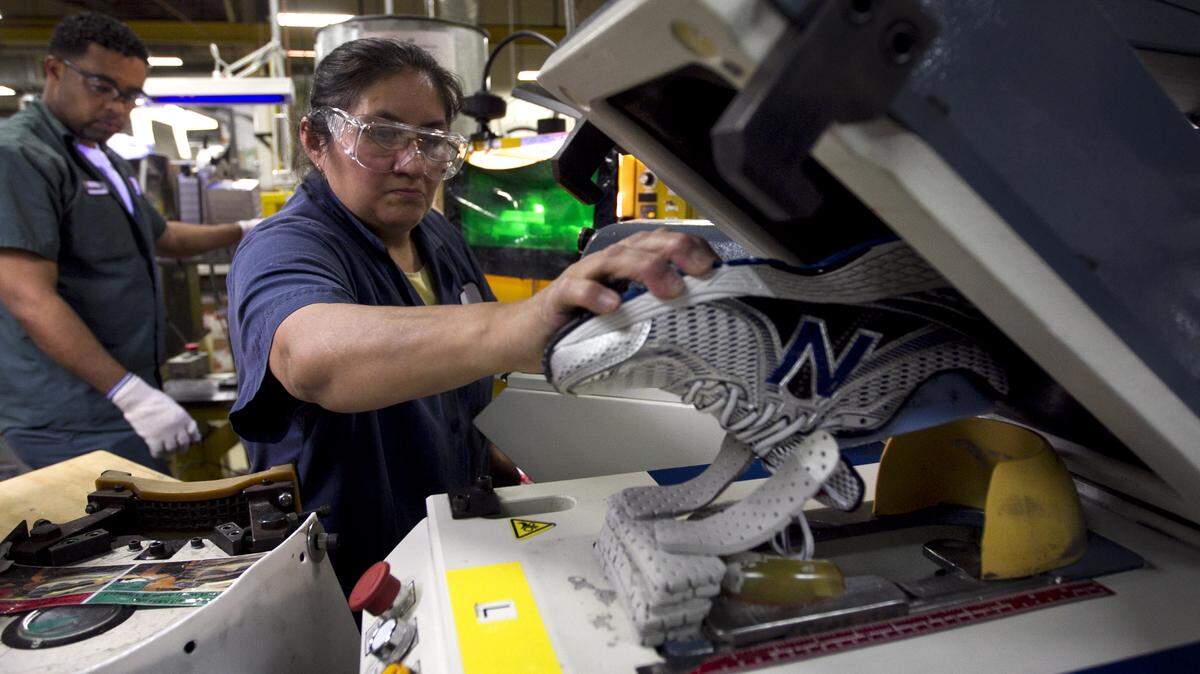 ASSOCIATED PRESS/FILEMaria Contrero removes a running shoe from a sole press during the assembly process at the New Balance factory in Boston in 2012.