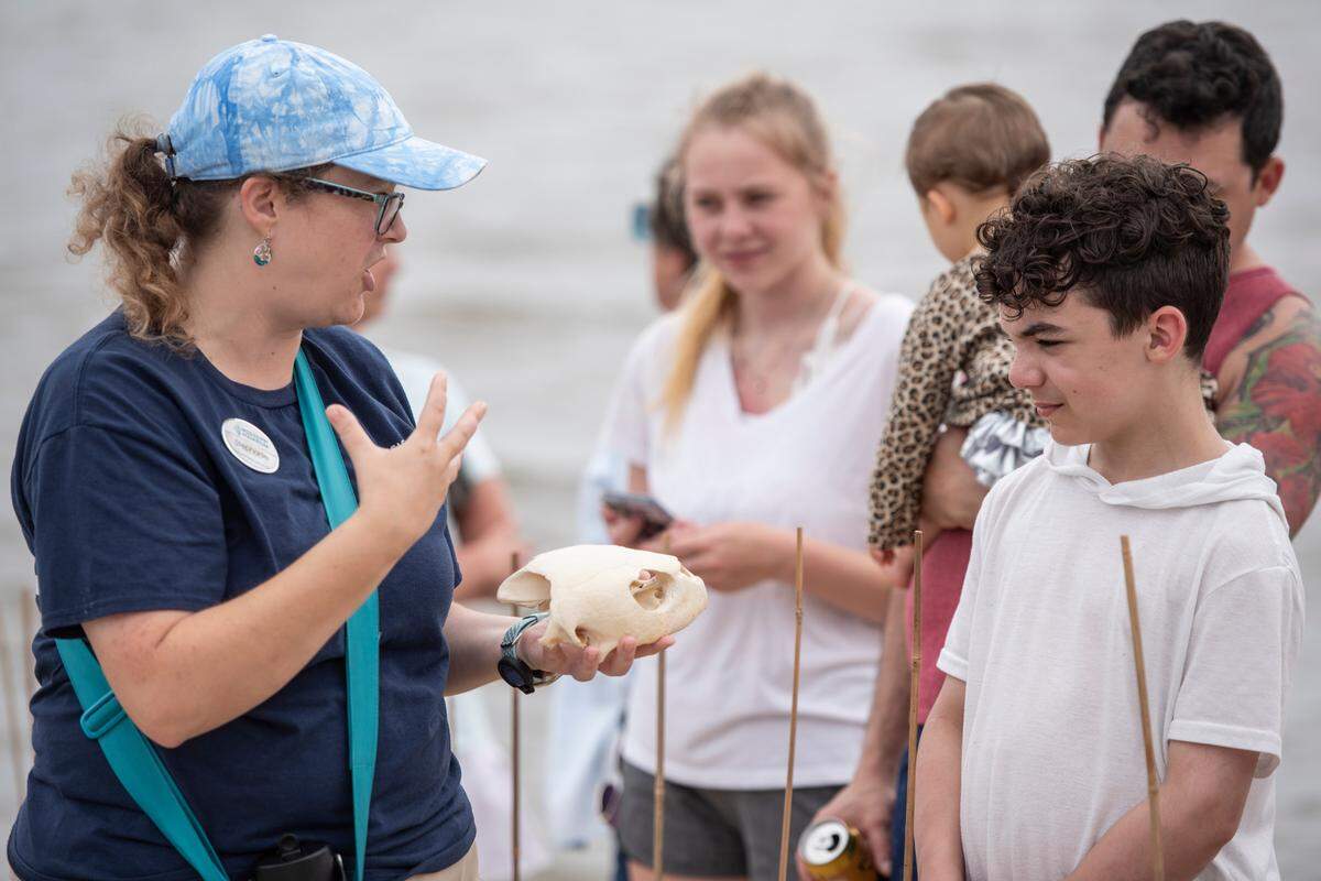 A Mississippi Aquarium worker teaches onlookers about Kemp’s Ridley sea turtles before 16 of them are released into the Mississippi Sound in Biloxi on Thursday, April 18, 2024.