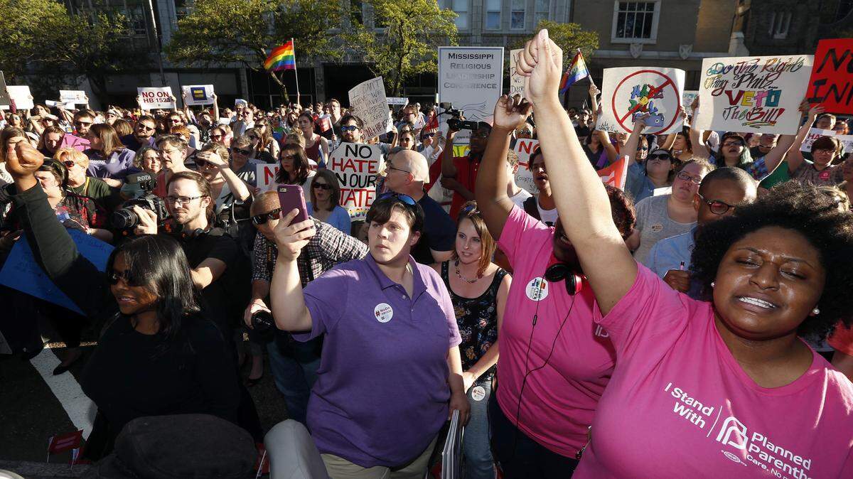 ROGELIO V. SOLIS/ASSOCIATED PRESS 
 Protesters call for Mississippi Gov. Phil Bryant to veto House Bill 1523, which they say will allow discrimination against LGBT people, during a rally outside the Governor's Mansion in Jackson on Monday. He signed the bill the next day.