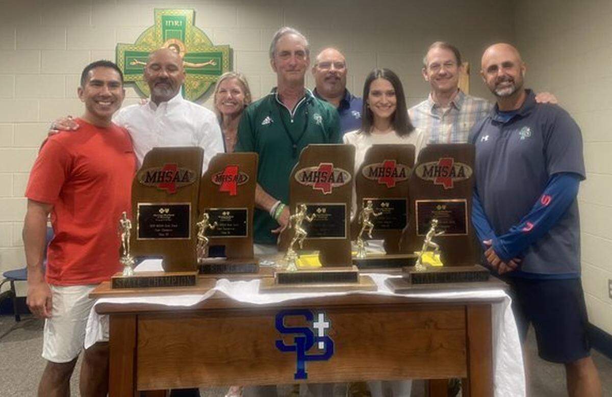 Stan Dellenger (middle) with his five state championship trophies.