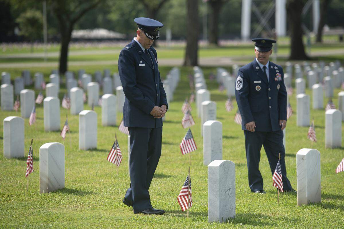 Col. Billy Pope, Commander of the 81st Training Wing at Keesler Air Force Base, left walks among the headstones during a Memorial Day ceremony at Biloxi National Cemetery in Biloxi on Monday, May 26, 2025.