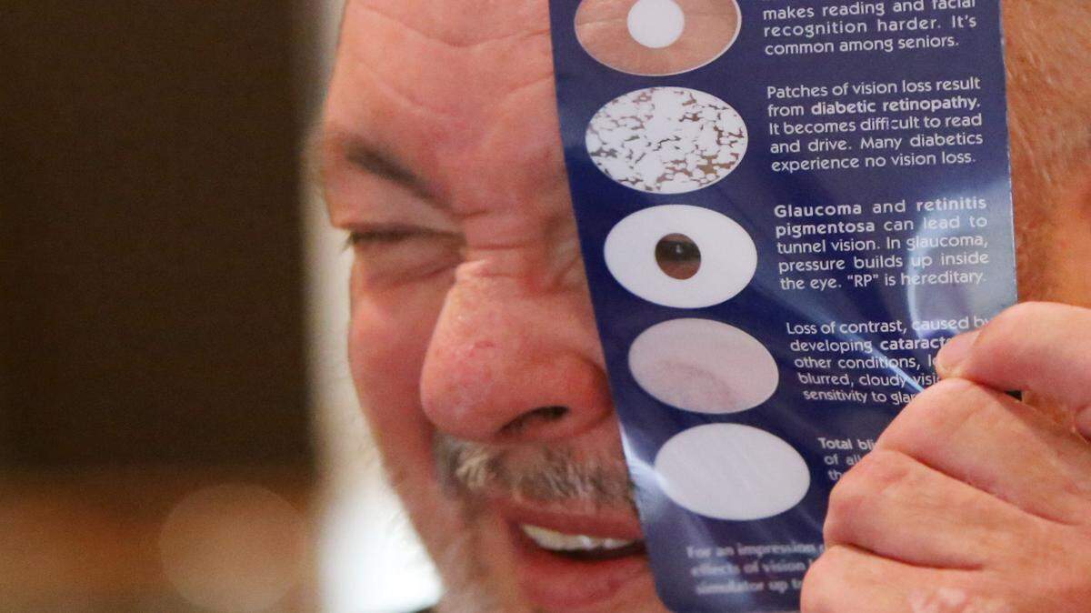 JOHN FITZHUGH/SUN HERALD 
 US Army eteran Ken McKelvain of Gulfport looks at an exhibit by the Gulf Coast Health Care Center's Blind Rehabilitation Center during a Welcome Home event for veterans at VFW Post 2434 in Biloxi on Saturday Oct. 24, 2015.
