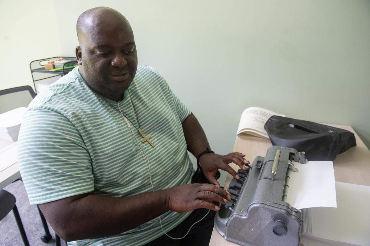 Antonio Williams, an instructor at the Mississippi Emerge Center, demonstrates a braille typewriter on Thursday, July 25, 2024.