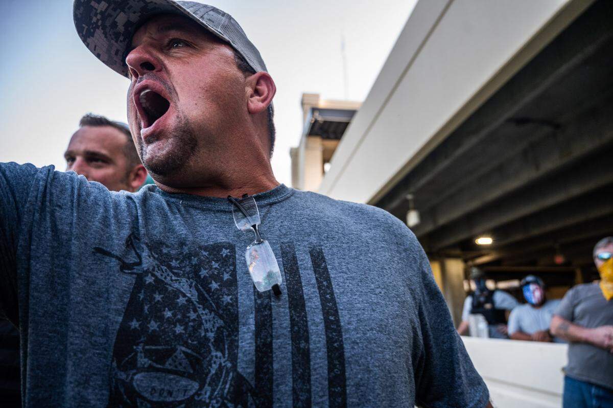 A member of the Southern Defense Force, a right-wing militia, shouts at a protester during a protest to take down the Confederate monument in front of the Harrison County Courthouse parking lot in Gulfport on Thursday, Sept. 3, 2020.