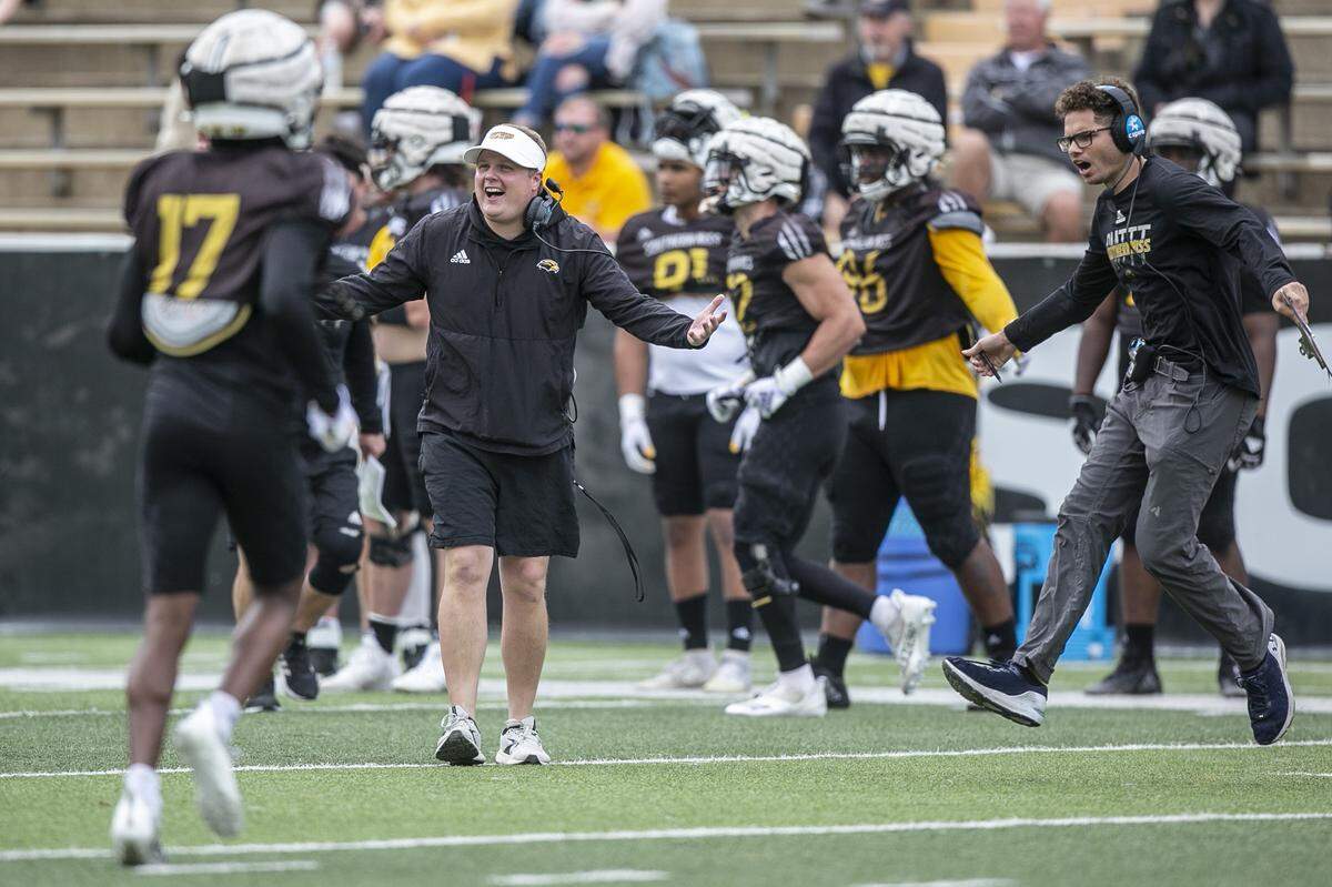 Defensive coordinator Austin Armstrong embraces his defensive players during the Spring Game at M.M. Roberts Stadium in Hattiesburg on Friday, April 1, 2022.