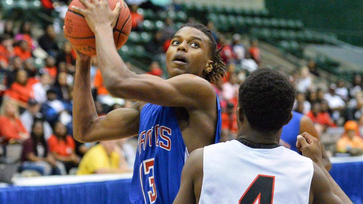 BOB SMITH/SPECIAL TO THE SUN HERALD 
 Pass Christian's Aydarius Young (13) shoots against Corinth during MHSAA 4A Quarterfinal play at the Mississippi Coliseum in Jackson.(Photo-Bob Smith)