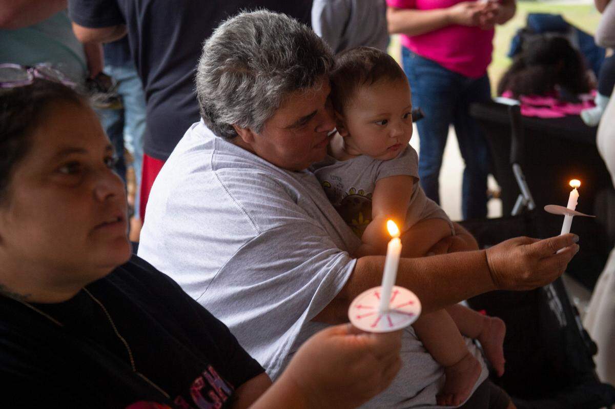 Vickie Wedgeworth Hutcherson, the mother of Gracelynn Vick, shows a candle to Beau, a family member’s child, during a candlelight vigil for Gracelynn at Saucier Park on Tuesday, April 22, 2025.