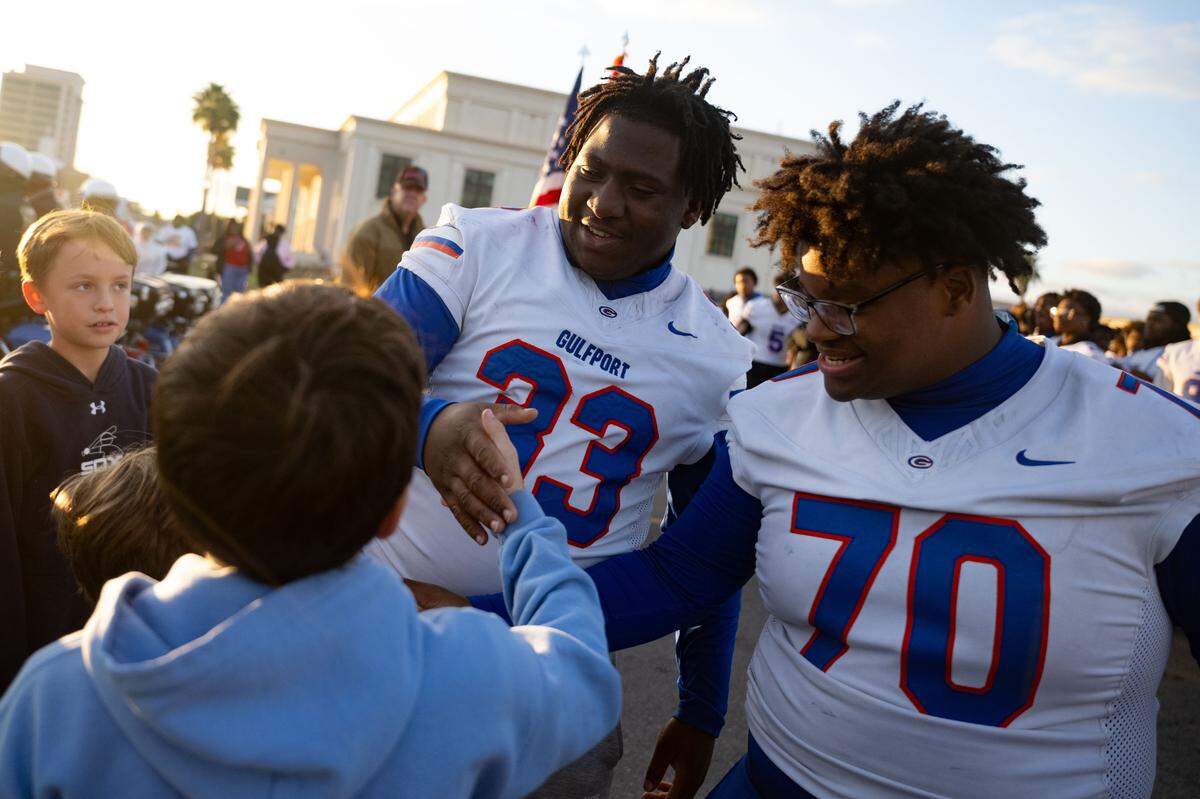Gulfport players meet up with parade attendees during the Champions Christmas Parade in Gulfport on Monday, Dec. 8, 2025.
