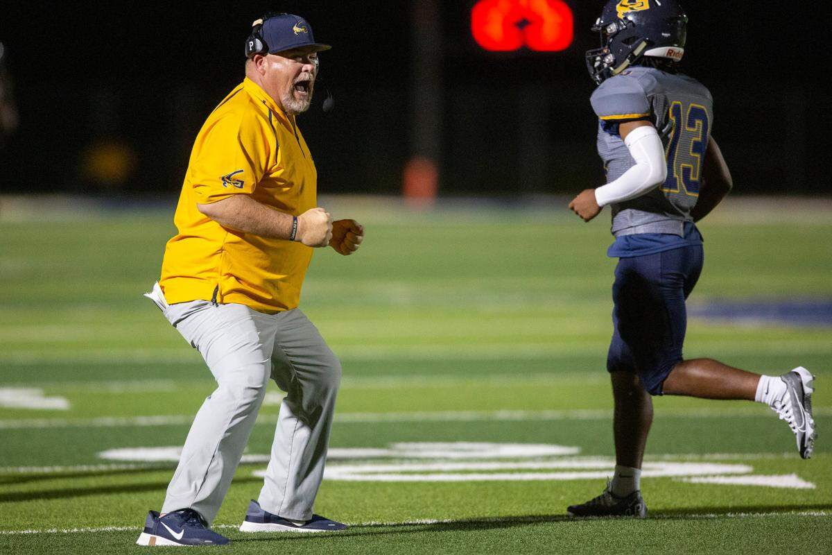 Gautier Head Coach Marc High celebrates as his players score a touchdown against Pascagoula at Gautier High School in Gautier on Friday, Sept. 2, 2022.