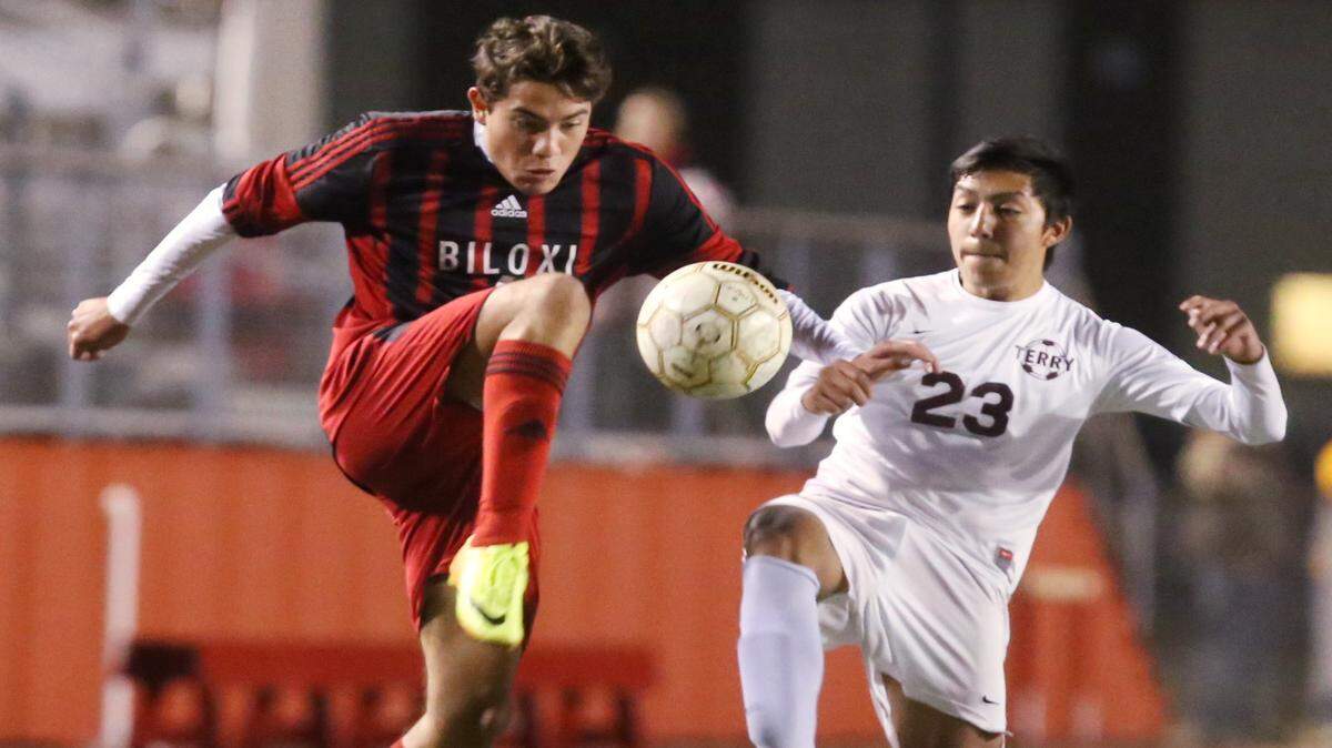 JOHN FITZHUGH/SUN HERALD 
 Biloxi's Nicolas Mateus beats Terry's Eliseo Tapia to the ball during the first half of their 6A first-round playoff game at Biloxi stadium on Wednesday Jan. 27, 2016.