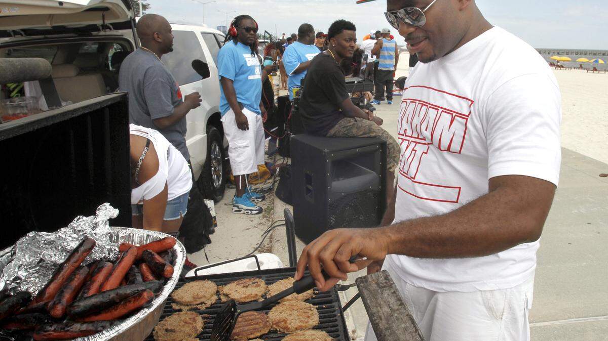 TIM ISBELL/SUN HERALD/FILE 
 Kelvin Graham of York, Ala., grills sausage, dogs and hamburgers at a previous Biloxi Black Beach Weekend. This year's event will be April 8-10.