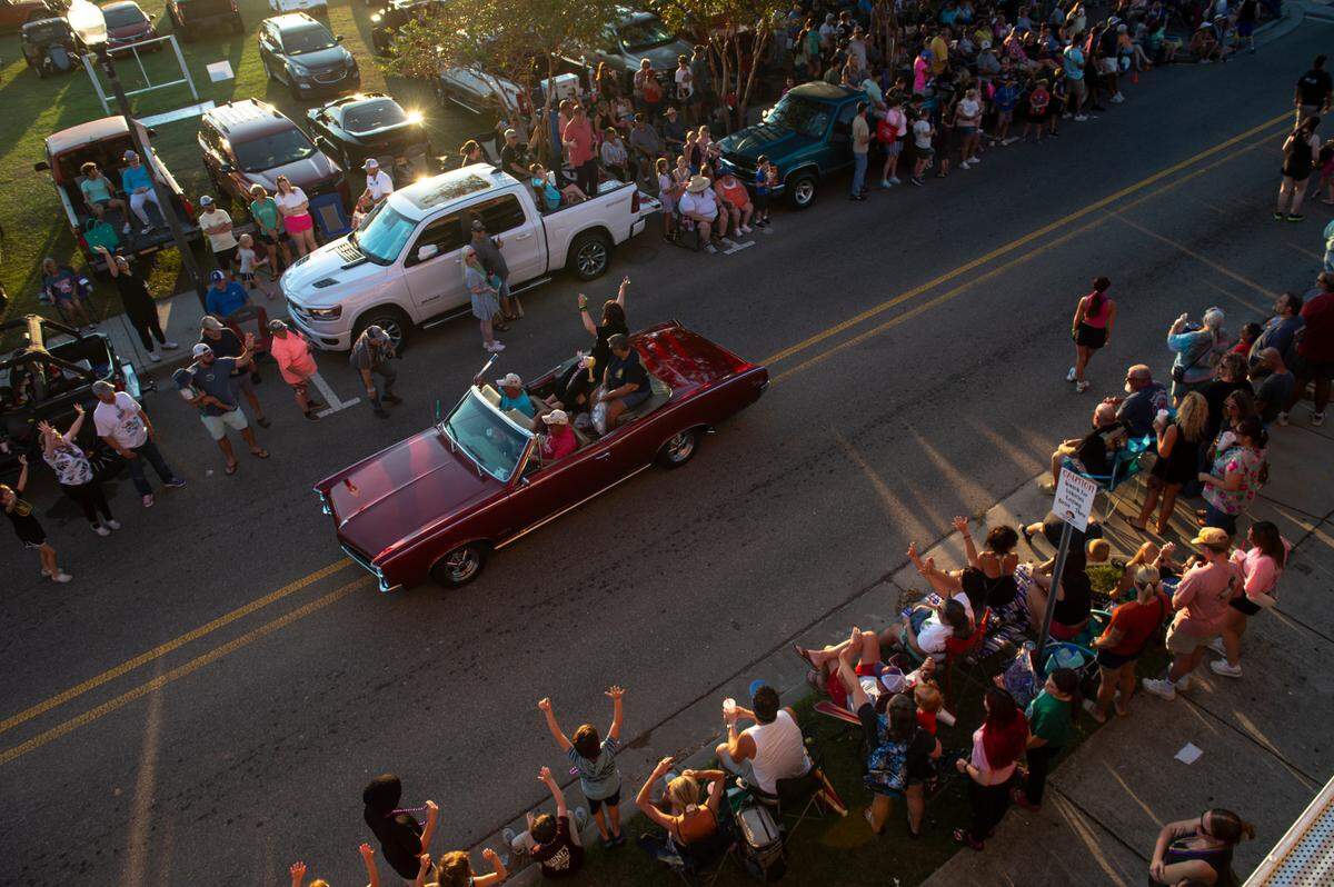 Cruisers drive down Jeff Davis Avenue during the Long Beach Parade in Long Beach, one of the events in Cruisin’ The Coast, on Monday, Oct. 7, 2024.