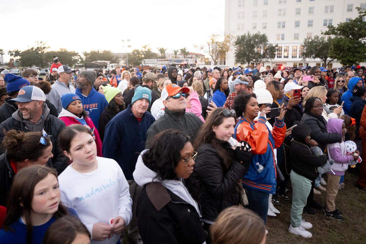 Parade attendees gather at a stage for the end of the Champion’ Christmas Parade in Gulfport on Monday, Dec. 8, 2025.