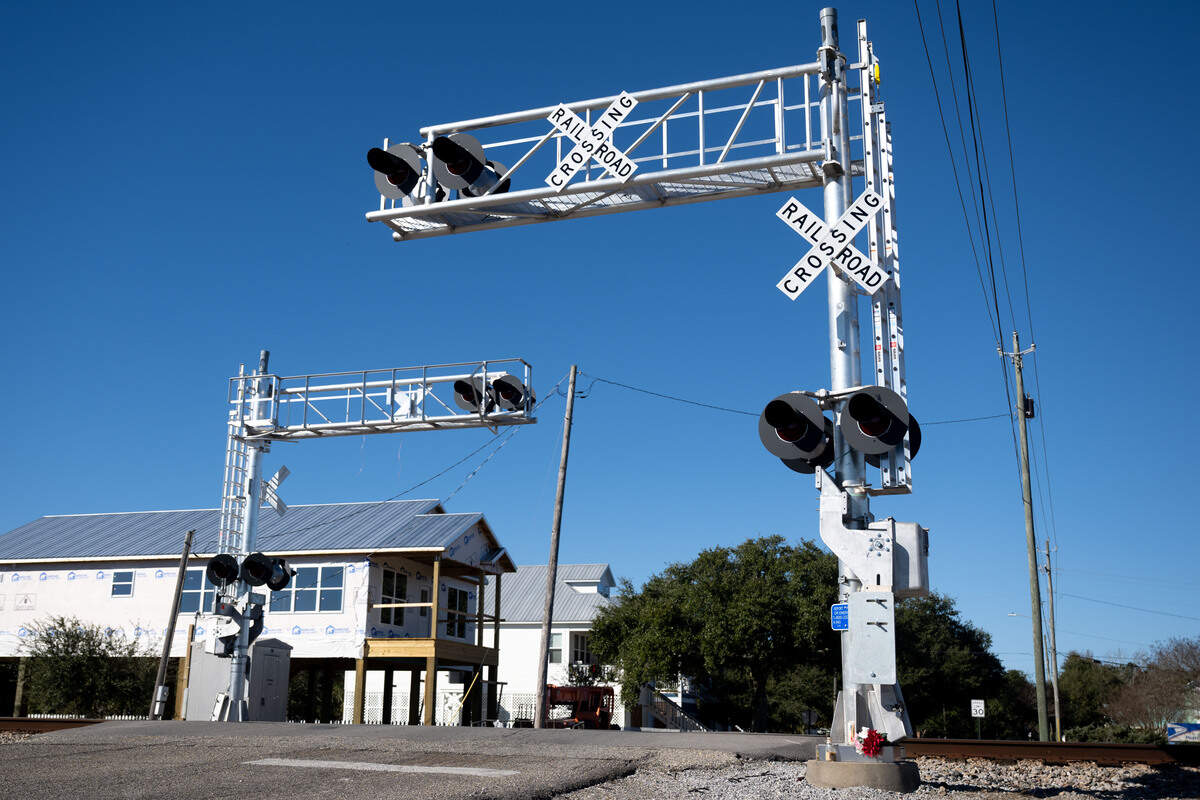 A railroad crossing sign and stoplight on Davis Avenue in Pass Christian on Friday, Dec. 19, 2025.