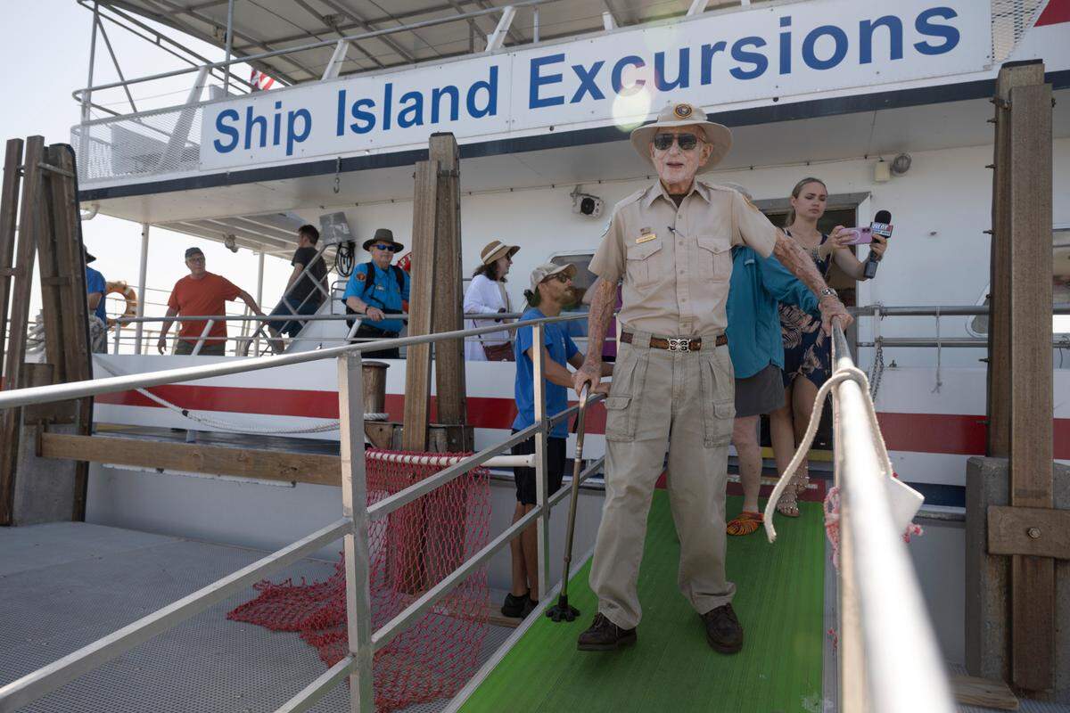 Jack Madison disembarks on Ship Island to give a final history tour on his 100th birthday, Friday, July 11, 2025.