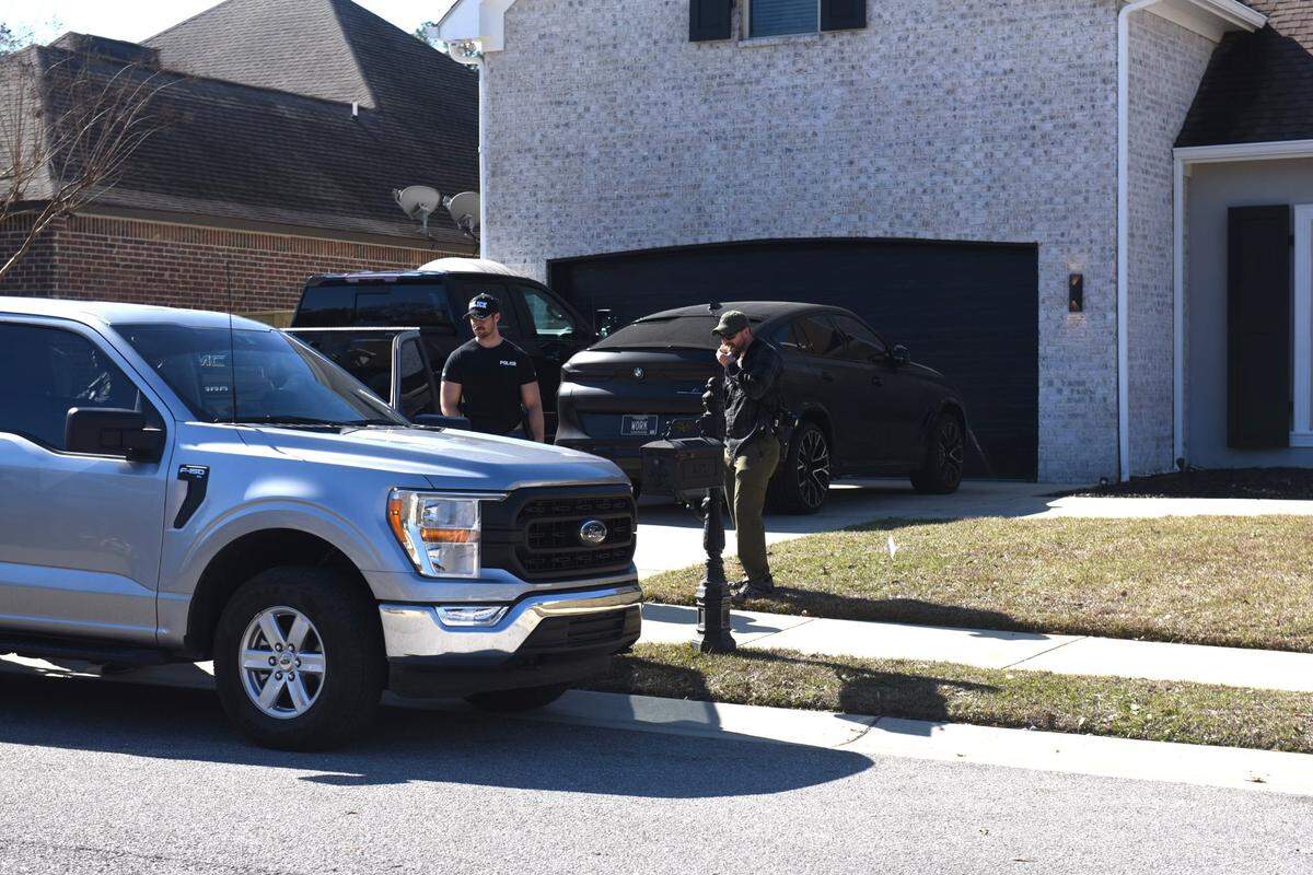Agents search the home and vehicles at the home of Biloxi Councilman Robert Deming III Thursday. The Candy Shop and Kratom locations also were raided by Drug Enforcement Administration and local police.