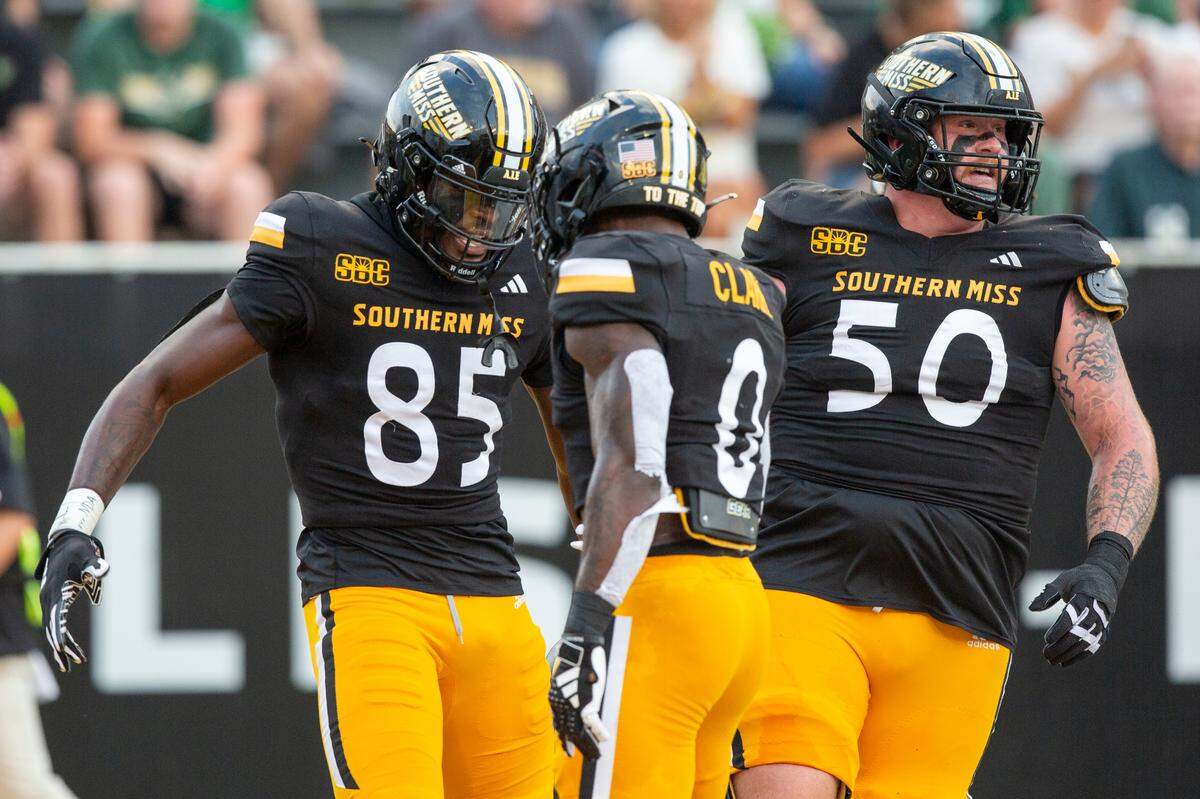 Southern Miss Golden Eagles tight end Kyirin Heath (85) and Southern Miss Golden Eagles running back Derek Clark (0) celebrate after a touchdown during a game between Southern Miss and South Florida at M.M. Roberts Stadium in Hattiesburg on Saturday, Sept. 14, 2024.
