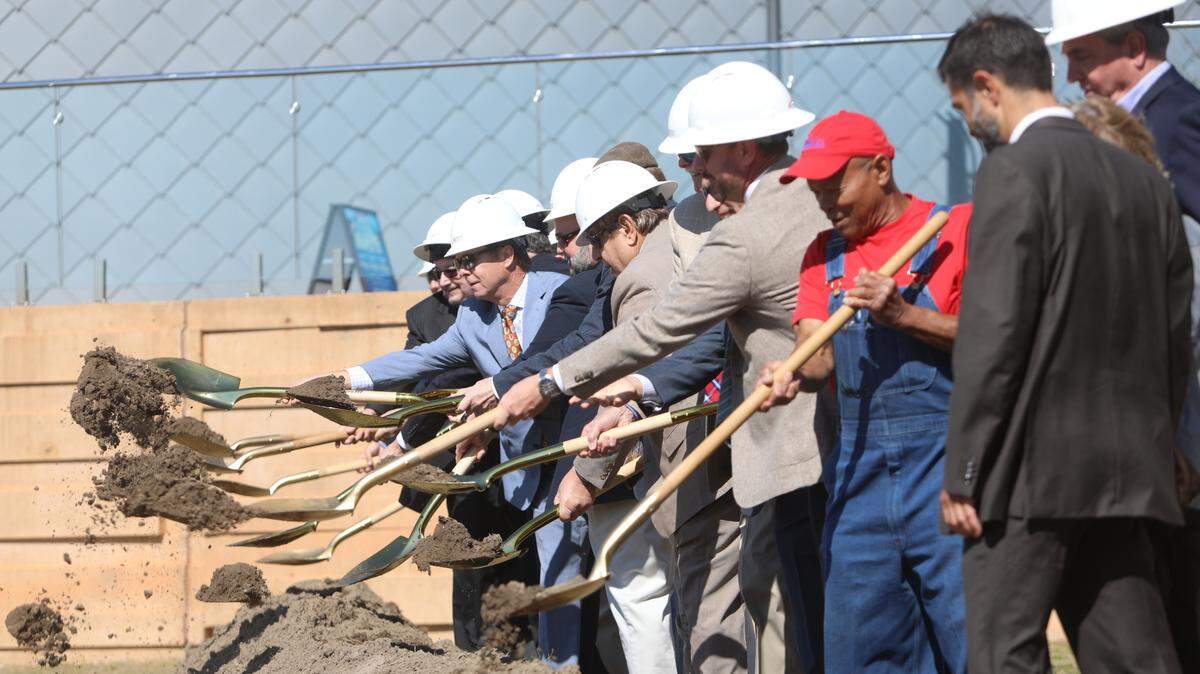 Gulfport Mayor Billy Hewes, center, other city council members, and officials from Mississippi Department of Transportation and Coast Transit Authority, as well as EGH architecture, break ground on an $18 million tram bridge that will connect Jones Park to the Mississippi Aquarium on Monday, March 21, 2022.