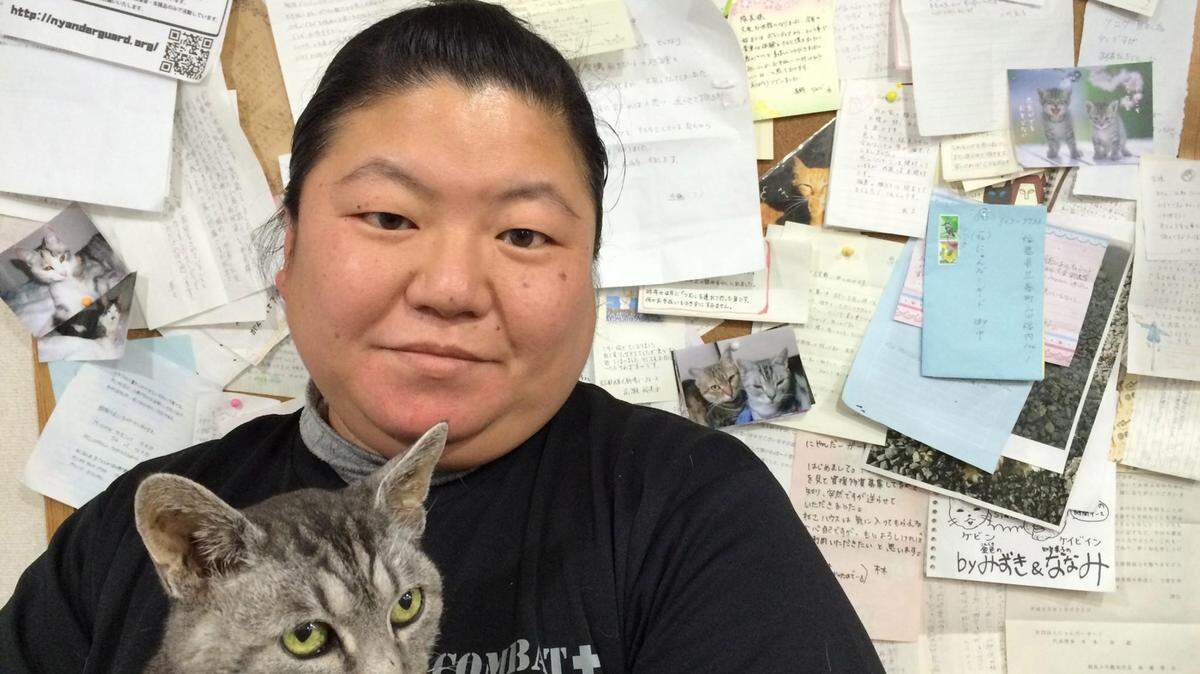 Takemi Shirota, an employee at the Nyander Guard animal shelter in Japan's Fukushima prefecture, holds a 20-year-old rescue cat named Kevin Costner. (Jonathan Kaiman/Los Angeles Times/TNS)
