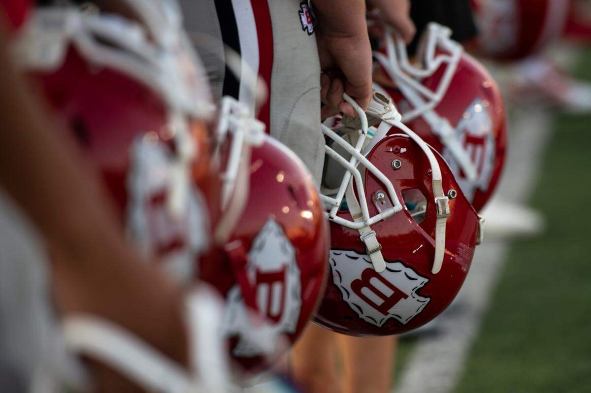 Biloxi football players hold their helmets on the sidelines during a Jamboree game against Gautier at Biloxi High School on Friday, Aug. 18, 2023.