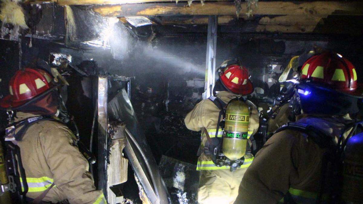 PAT SULLIVAN 
 Firefighters check damage and for hot spots after putting out a fire in west Harrison County on Wednesday night. No one was injured.