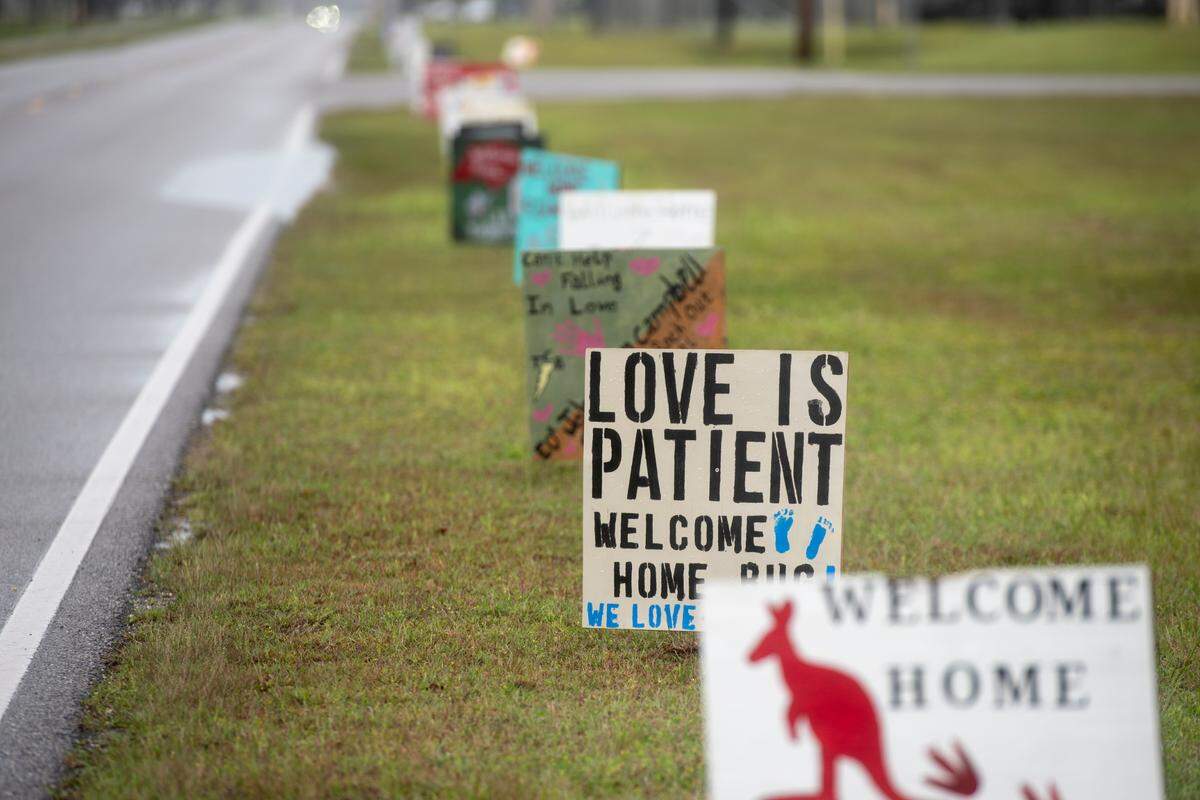 Signs made by family members of Naval Mobile Construction Battalion 133 to welcome them home from deployment line the streets at the Naval Construction Battalion Center in Gulfport on Tuesday, March 5, 2024.