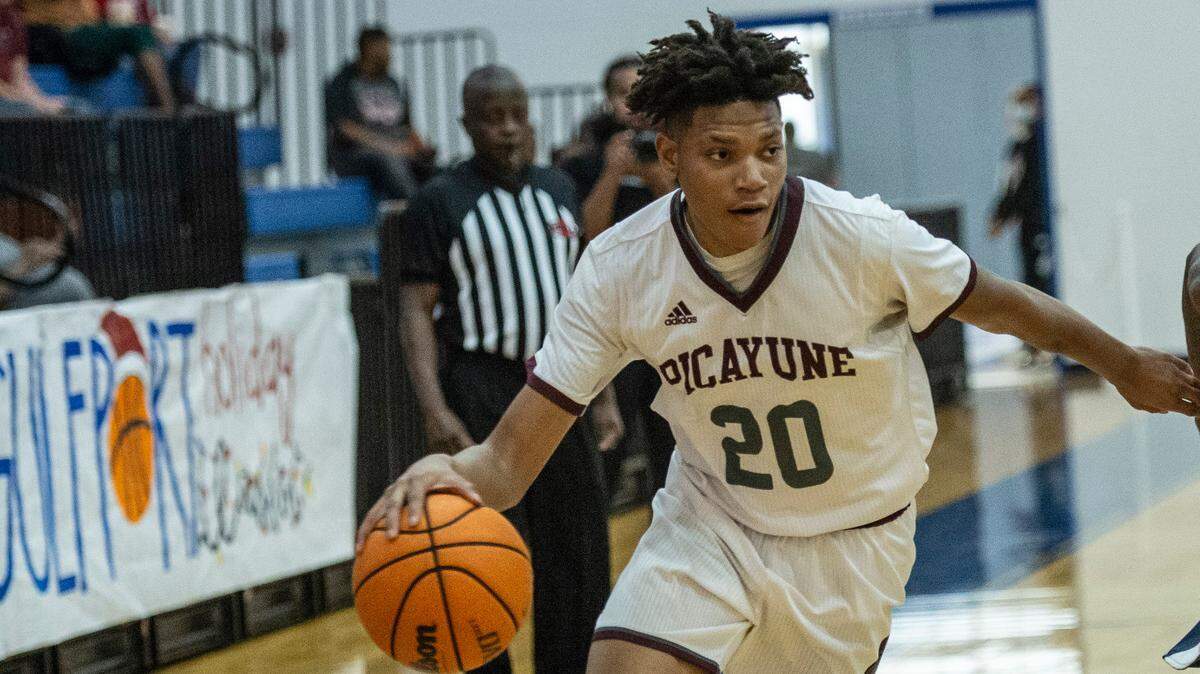 Picayune’s Troy Carter, left, dribbles the ball down the court during a matchup with Wayne County during the Adidas Holiday Classic at Gulfport High School in Gulfport on Tuesday, Dec. 28, 2021.