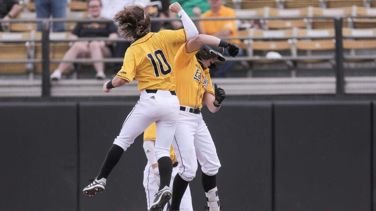 Southern Miss’s Dustin Dickerson (10) celebrates with Christopher Sargent (41) after they both scored on Sargent’s first home run against UConn on Saturday, February 27, 2021.