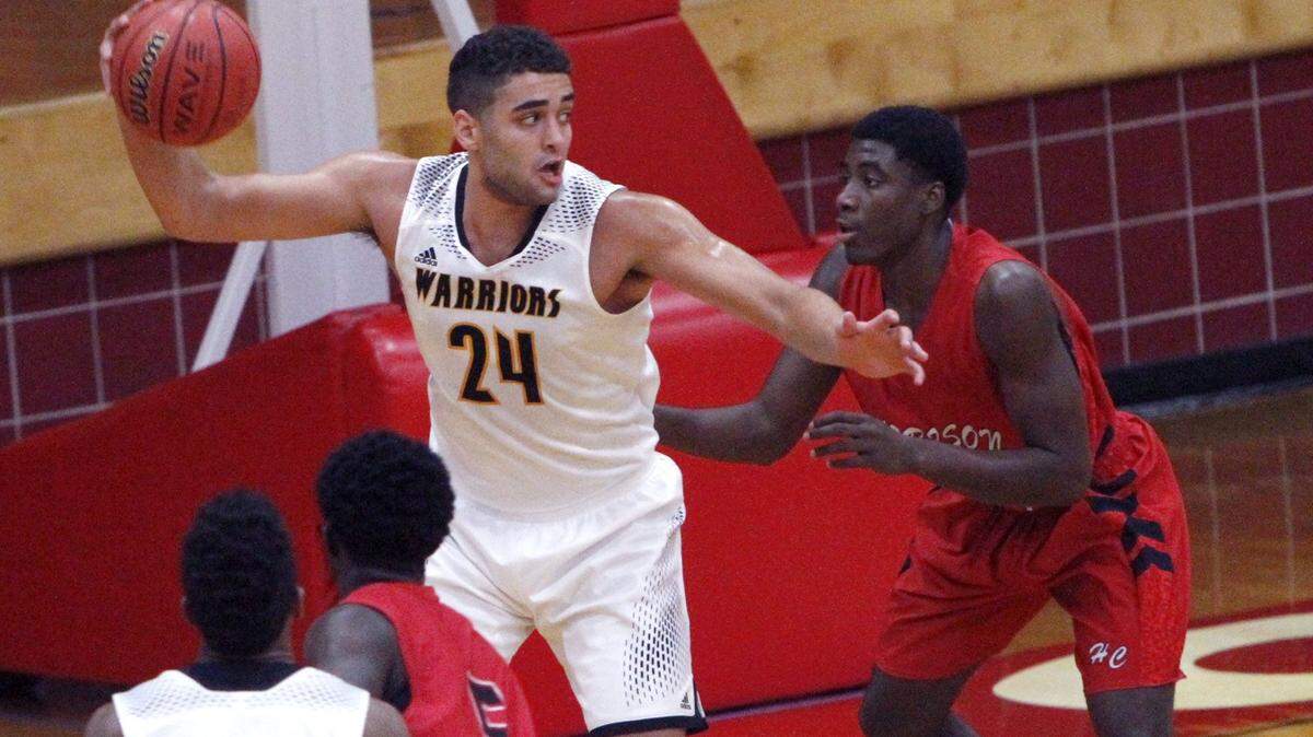 TIM ISBELL/SUN HERALD 
 D'Iberville's Evan Howard looks for an open teammate after grabbing a rebound against Harrison Central at the Jackie Laird Tournament on Dec. 18 at the Biloxi Sports Arena. D'Iberville entertains St. Martin on Friday night in the Region 7-6A opener for both teams.