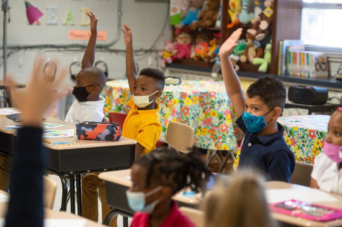 Students raise their hands in Ms. Holliman’s first grade class on the first day of school at Gautier Elementary on Monday, July 5, 2021. Pascagoula-Gautier School District implemented a mask mandate at the start of the 2021-2022 school year.