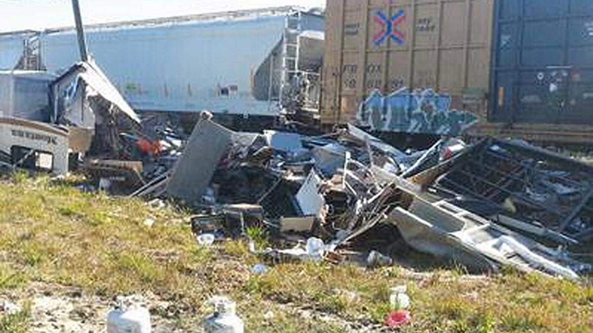 DWAYNE BREMER/SEA COAST ECHO 
 
 A train hit a camper that had stalled on the tracks at Clermont Boulevard on Monday, destroying it. A couple in a truck that was pulling the camper were not injured.