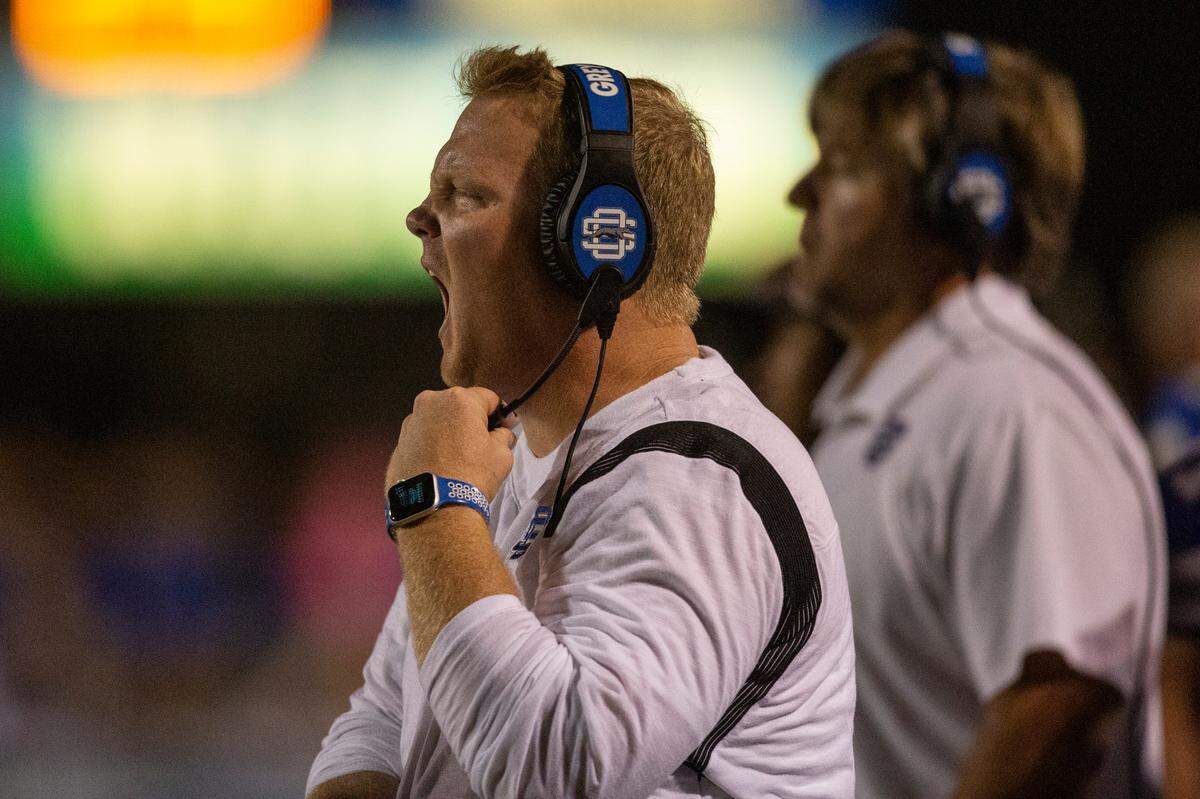 Ocean Springs High School Football Head Coach Blake Pennock yells from the sidelines during a game at Greyhound Stadium in Ocean Springs on Friday, Oct. 28, 2022.