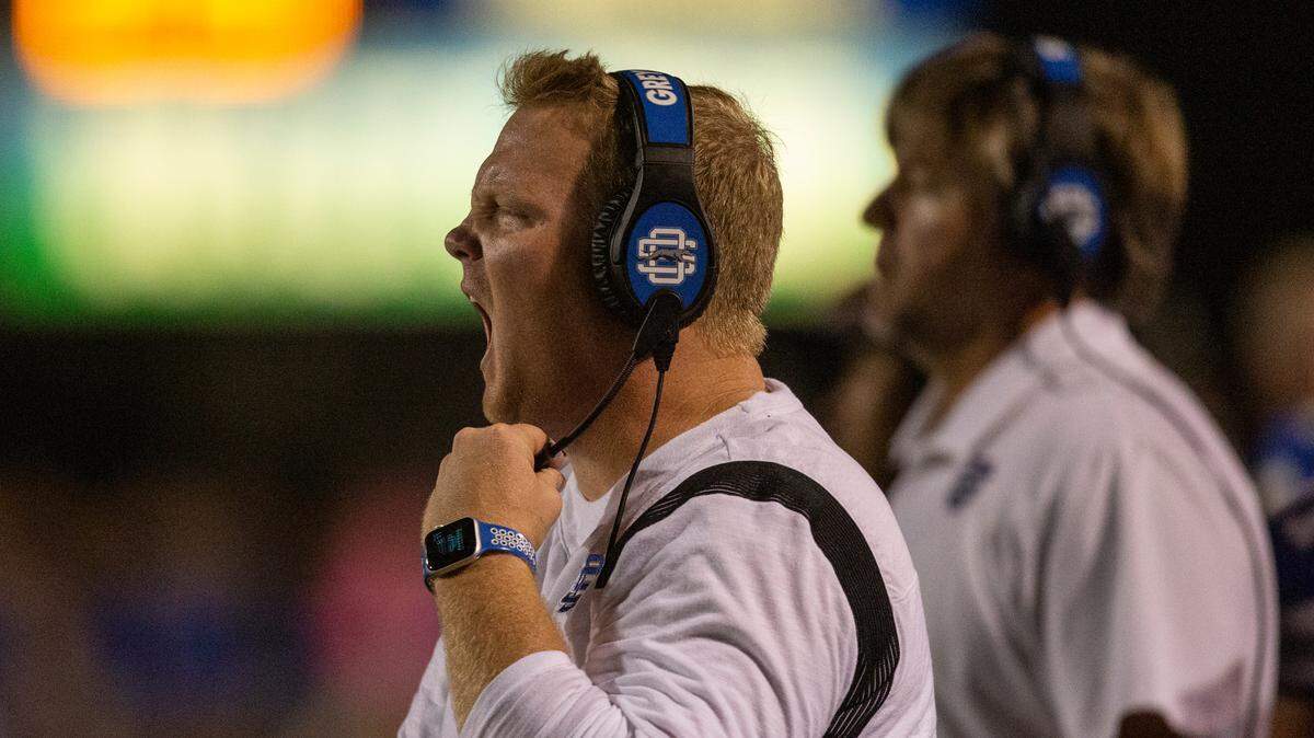 Ocean Springs High School Football Head Coach Blake Pennock yells from the sidelines during a game at Greyhound Stadium in Ocean Springs on Friday, Oct. 28, 2022.
